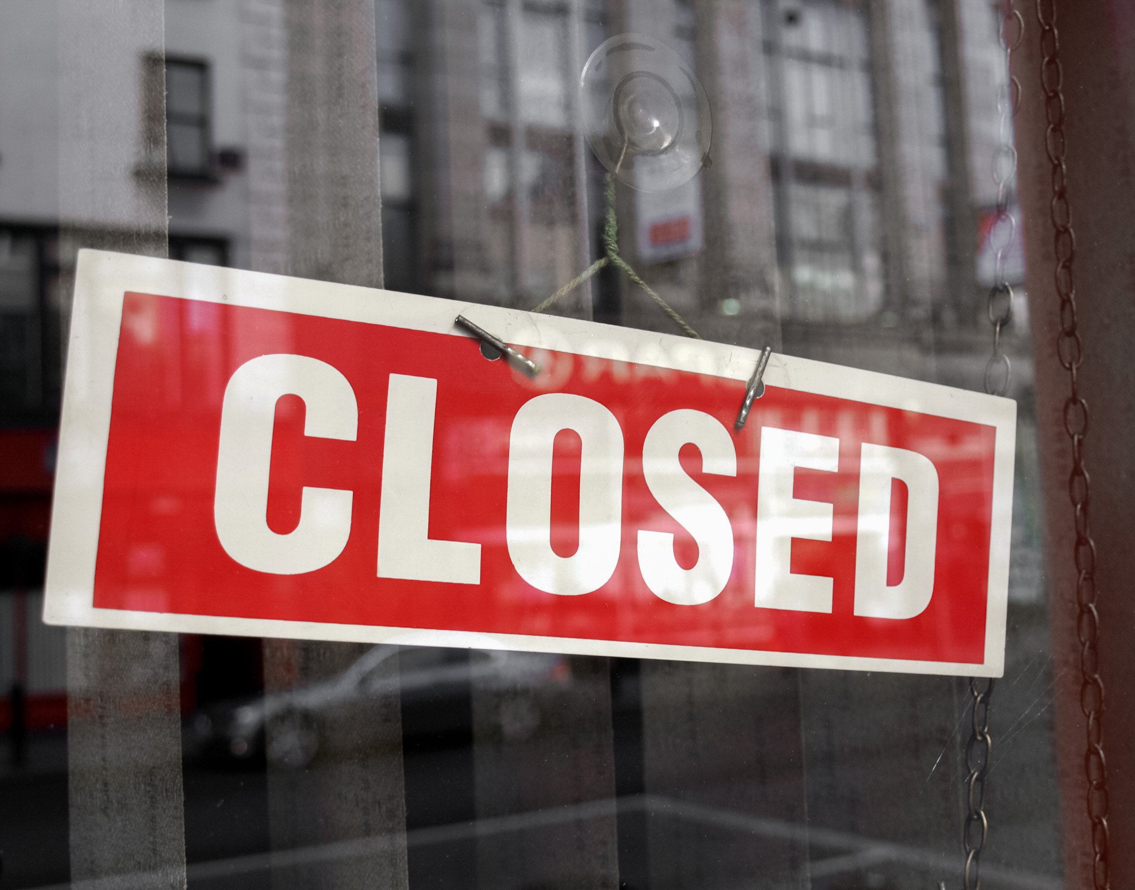 photo of a sign labeled closed on a business window